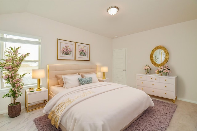 bedroom with baseboards and vaulted ceiling