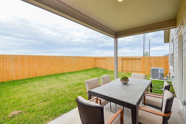 view of patio / terrace with a fenced backyard, outdoor dining area, and central AC unit