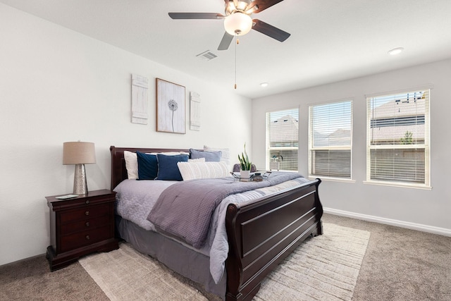bedroom featuring light colored carpet, ceiling fan, and baseboards