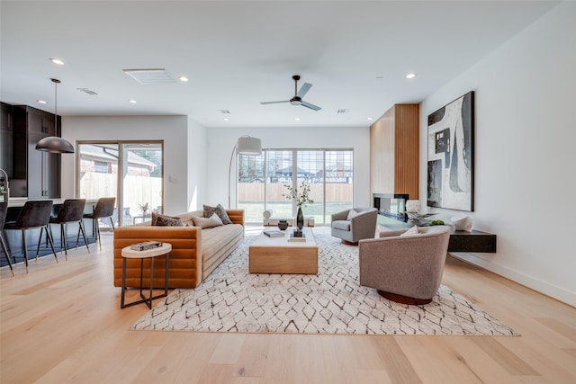 living area with a healthy amount of sunlight, recessed lighting, and light wood finished floors