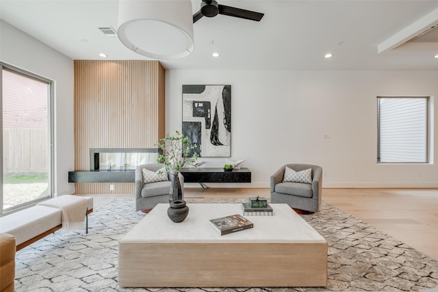 living area with a fireplace, wood finished floors, visible vents, ceiling fan, and recessed lighting