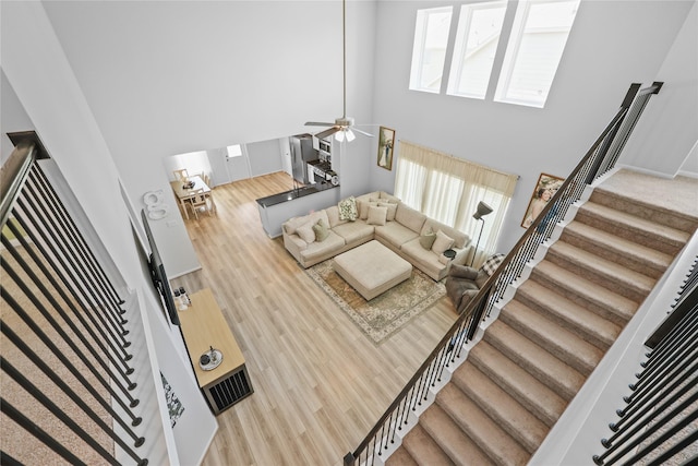 30208 Arnold Branch Dr, Magnolia, TX 77355 - living room with plenty of natural light, stairs, a towering ceiling, and wood finished floors