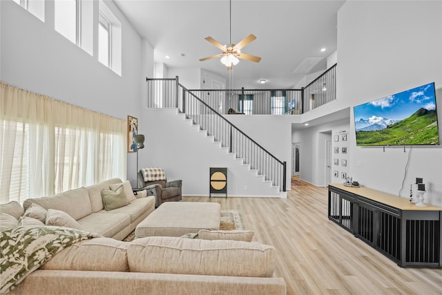 30208 Arnold Branch Dr, Magnolia, TX 77355 - living area featuring ceiling fan, light wood-style flooring, recessed lighting, a towering ceiling, and stairway
