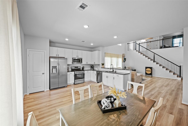 30208 Arnold Branch Dr, Magnolia, TX 77355 - dining room with recessed lighting, light wood-type flooring, stairs, and visible vents