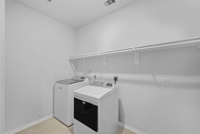 30208 Arnold Branch Dr, Magnolia, TX 77355 - clothes washing area featuring laundry area, baseboards, separate washer and dryer, and visible vents