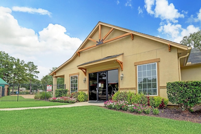 30208 Arnold Branch Dr, Magnolia, TX 77355 - view of front facade featuring stucco siding, a front yard, and fence