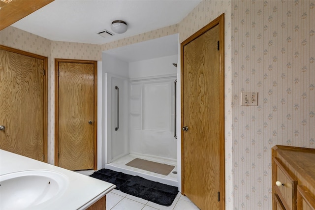 16002 Castaway Ct, Crosby, TX 77532 - bathroom featuring wallpapered walls, a stall shower, vanity, and tile patterned floors