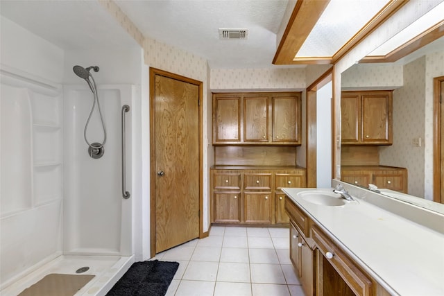 16002 Castaway Ct, Crosby, TX 77532 - bathroom featuring wallpapered walls, a shower stall, vanity, and tile patterned floors