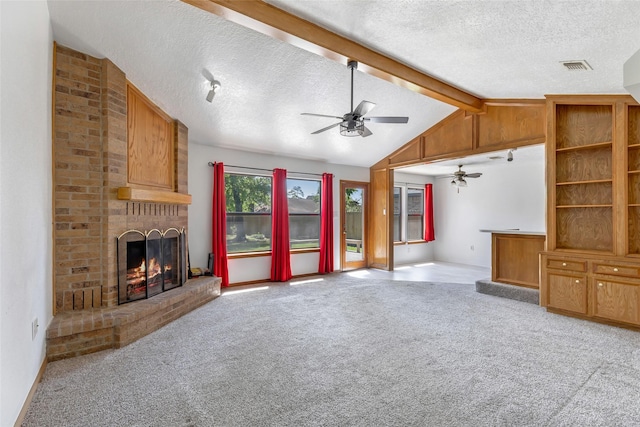 16002 Castaway Ct, Crosby, TX 77532 - unfurnished living room with a ceiling fan, a textured ceiling, a fireplace, and light carpet
