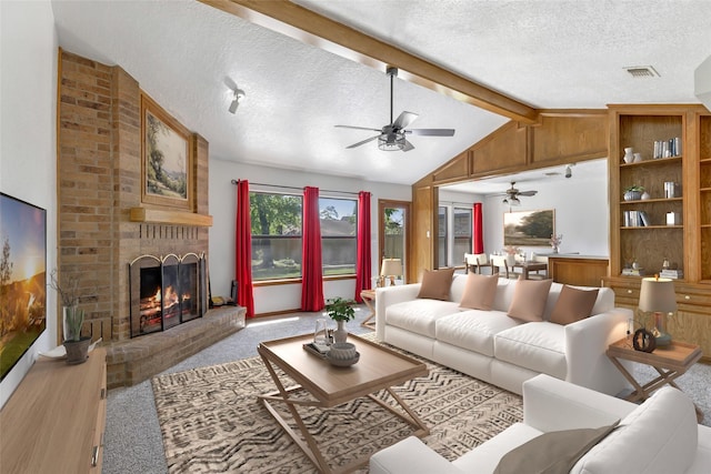 16002 Castaway Ct, Crosby, TX 77532 - carpeted living area featuring a ceiling fan, a textured ceiling, and a brick fireplace