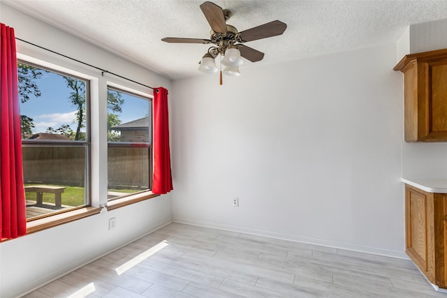 16002 Castaway Ct, Crosby, TX 77532 - spare room with a textured ceiling, ceiling fan, light wood-type flooring, and baseboards