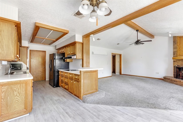 16002 Castaway Ct, Crosby, TX 77532 - kitchen featuring ceiling fan, under cabinet range hood, light countertops, black appliances, and open floor plan