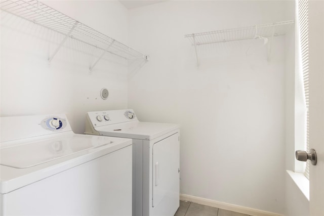18911 Brownstone Mills Dr, Cypress, TX 77433 - laundry room featuring separate washer and dryer, light tile patterned floors, and baseboards
