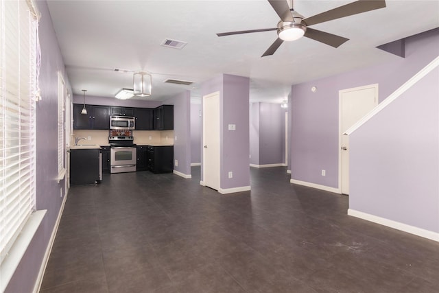 18911 Brownstone Mills Dr, Cypress, TX 77433 - unfurnished living room featuring a sink, baseboards, and ceiling fan