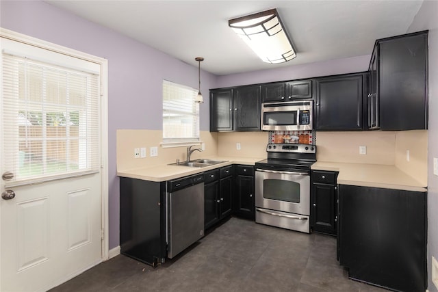 18911 Brownstone Mills Dr, Cypress, TX 77433 - kitchen with appliances with stainless steel finishes, a sink, dark cabinetry, and light countertops