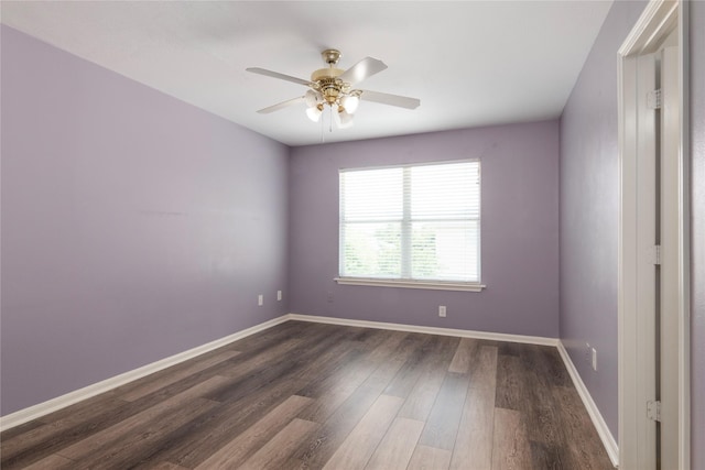 18911 Brownstone Mills Dr, Cypress, TX 77433 - empty room featuring dark wood-style flooring, ceiling fan, and baseboards
