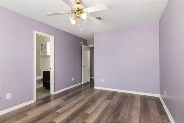 18911 Brownstone Mills Dr, Cypress, TX 77433 - unfurnished bedroom featuring wood finished floors, baseboards, ceiling fan, and ensuite bathroom