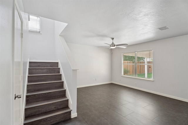 18911 Brownstone Mills Dr, Cypress, TX 77433 - stairway with ceiling fan, baseboards, and a textured ceiling