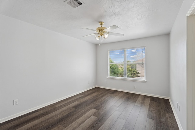 18911 Brownstone Mills Dr, Cypress, TX 77433 - spare room with dark wood-type flooring, baseboards, a ceiling fan, and a textured ceiling