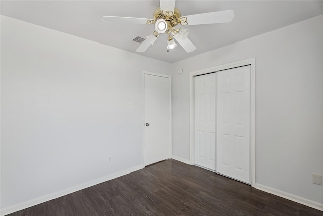 18911 Brownstone Mills Dr, Cypress, TX 77433 - unfurnished bedroom featuring dark wood finished floors, baseboards, and a closet