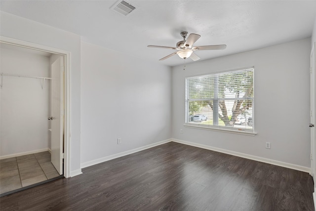18911 Brownstone Mills Dr, Cypress, TX 77433 - unfurnished bedroom featuring dark wood-type flooring, a closet, baseboards, and ceiling fan