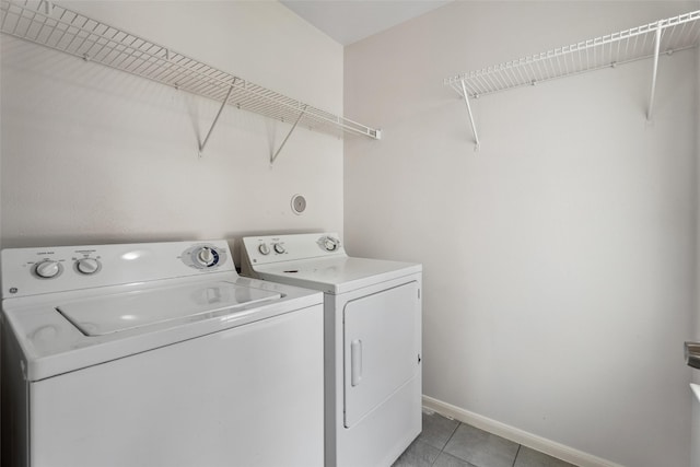 18911 Brownstone Mills Dr, Cypress, TX 77433 - washroom with separate washer and dryer, baseboards, and light tile patterned floors