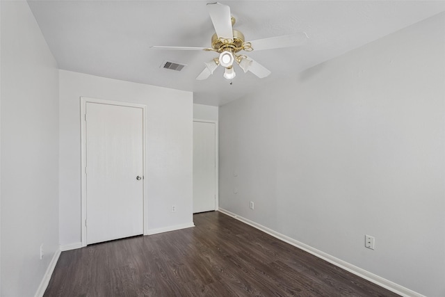 18911 Brownstone Mills Dr, Cypress, TX 77433 - unfurnished bedroom with dark wood-type flooring, baseboards, and a ceiling fan