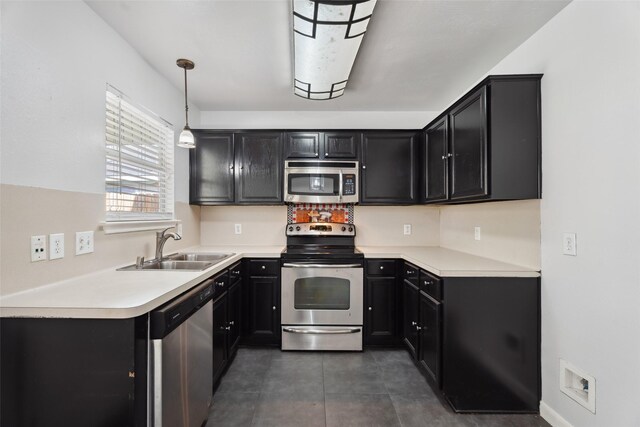 18911 Brownstone Mills Dr, Cypress, TX 77433 - kitchen with appliances with stainless steel finishes, a sink, dark cabinetry, and light countertops