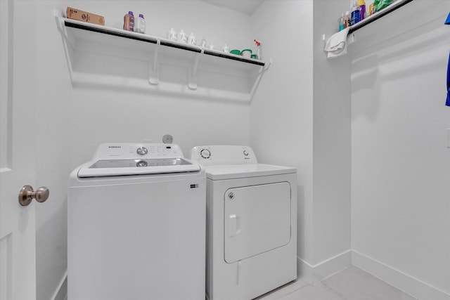 7914 Starfish Arbor Dr, Cypress, TX 77433 - laundry room featuring washer and dryer, baseboards, and light tile patterned floors