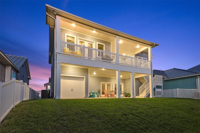 back of house featuring fence, central AC, and a yard