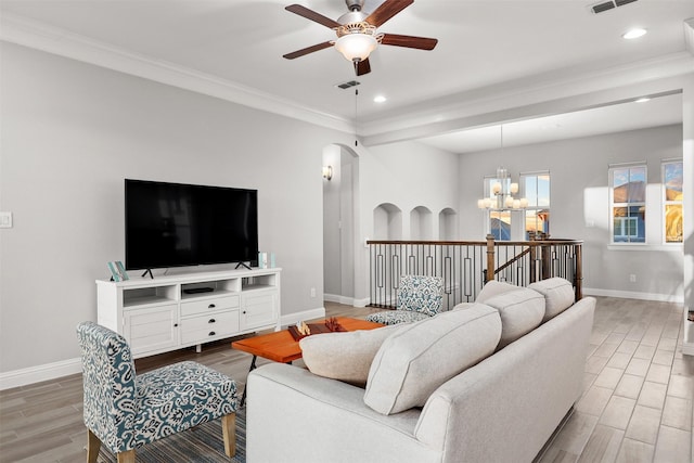 living room with baseboards, wood finished floors, and ceiling fan with notable chandelier