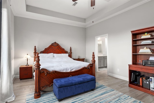 bedroom featuring wood tiled floor, visible vents, and a raised ceiling
