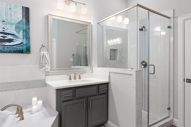 bathroom with a washtub, a stall shower, and vanity