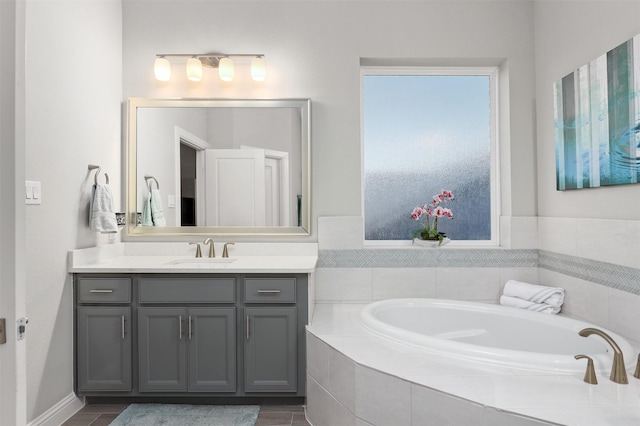 full bath featuring vanity and a bath