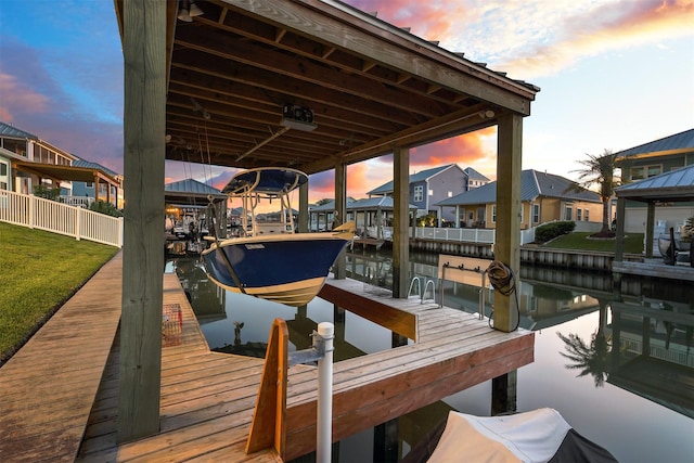dock area with a residential view and boat lift