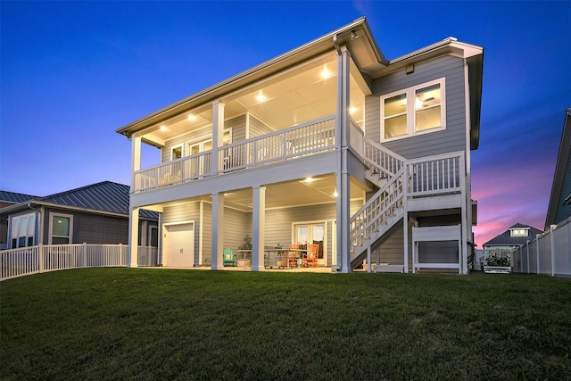 back of property featuring stairs, fence, a patio area, and a lawn