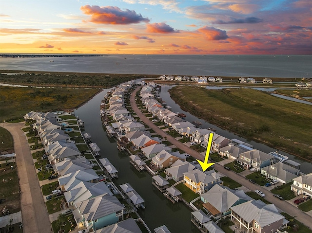 drone / aerial view with a residential view and a water view