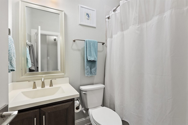 full bathroom with toilet, vanity, and a shower with curtain