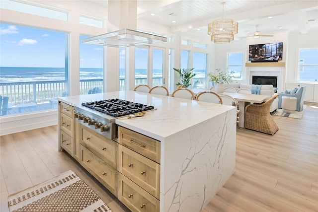 11367 Beachside Dr, Galveston, TX 77554 - kitchen featuring a large fireplace, light wood-style flooring, island exhaust hood, and gas stovetop