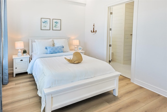 11367 Beachside Dr, Galveston, TX 77554 - bedroom featuring baseboards and light wood finished floors