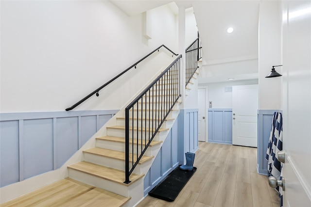 11367 Beachside Dr, Galveston, TX 77554 - staircase with a wainscoted wall, recessed lighting, wood finished floors, and a decorative wall