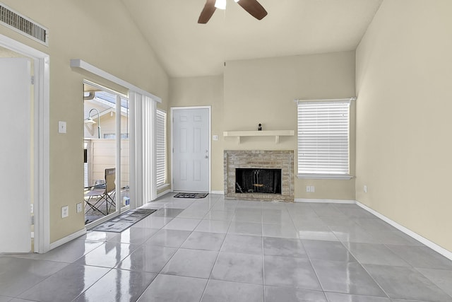 unfurnished living room with visible vents, baseboards, a fireplace, ceiling fan, and tile patterned flooring