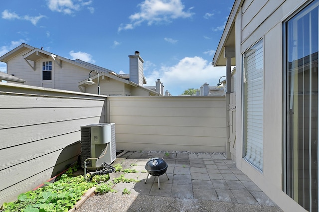 view of patio featuring central AC, a fire pit, and a fenced backyard