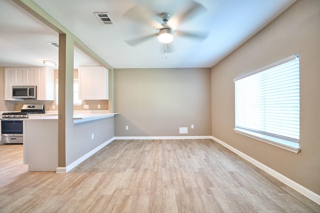 12234 Dumas St, Houston, TX 77034 - kitchen featuring stainless steel appliances, ceiling fan, white cabinetry, and healthy amount of natural light