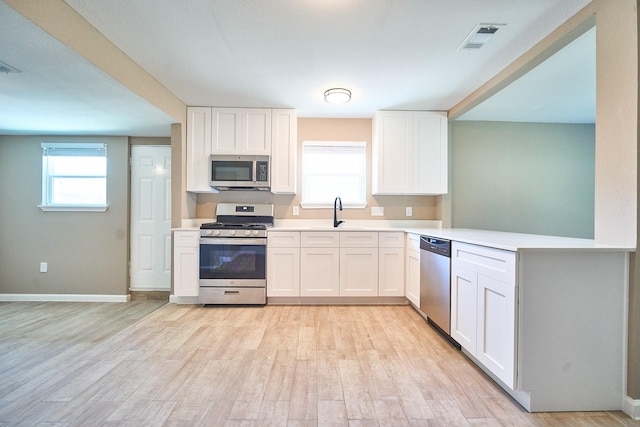 12234 Dumas St, Houston, TX 77034 - kitchen with appliances with stainless steel finishes, light countertops, and light wood finished floors