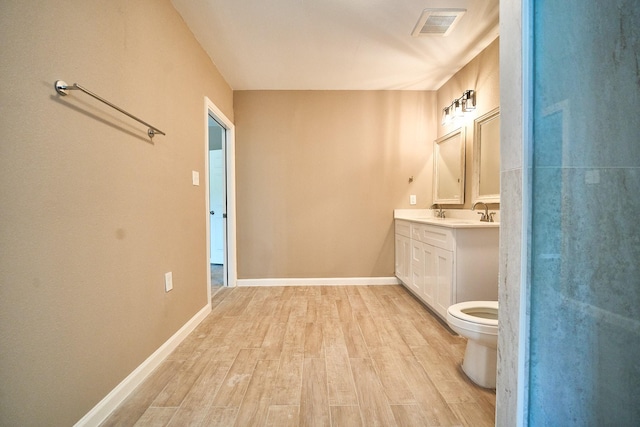 12234 Dumas St, Houston, TX 77034 - bathroom with wood finished floors, double vanity, toilet, and baseboards