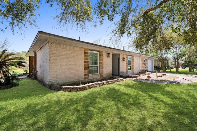 5401 Bayou Dr, Dickinson, TX 77539 - ranch-style house featuring an attached garage, a front lawn, and brick siding