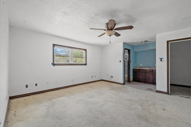 5401 Bayou Dr, Dickinson, TX 77539 - unfurnished bedroom featuring a sink, concrete floors, a textured ceiling, baseboards, and ceiling fan