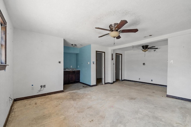 5401 Bayou Dr, Dickinson, TX 77539 - interior space featuring concrete flooring, baseboards, a textured ceiling, visible vents, and a ceiling fan
