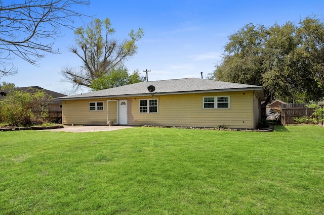 5401 Bayou Dr, Dickinson, TX 77539 - back of house with fence, a patio area, and a lawn